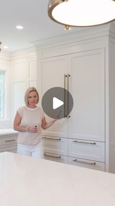 a woman standing in front of a kitchen counter