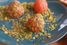 two oranges are on a blue plate with sprinkles and seeds around them