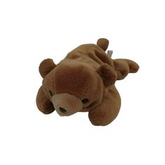 a brown stuffed animal laying on its side