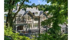 a large house surrounded by trees and greenery