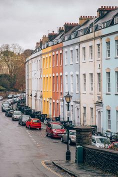 a row of multi - colored buildings line the street