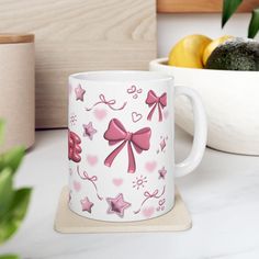 a pink bow coffee mug sitting on top of a counter