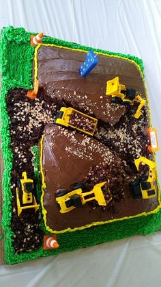 a birthday cake with construction vehicles on it