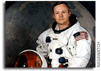 an astronaut is sitting in front of the moon with his helmet on and looking at the camera