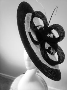 This is a gorgeous wide brim hat handcrafted with sinamay, mat and cord lace. This is a must have for mothers of bride/groom for that special day, it is also ideal for Derby, Royal ascot, wedding guest and all your special occasions. We don't repeat our designs, please get this before it's gone. It comes in black/ivory and red/ivory. Elegant Handmade Boater Hat With Flat Brim, Handmade Elegant Boater Hat With Flat Brim, Handmade Elegant Flat Brim Boater Hat, Beach Short Brim Sinamay Fascinator, Elegant Handmade Brimmed Hat, Elegant Handmade Top Hat With Short Brim, Elegant Handmade Flat Brim Straw Hat, Handmade Elegant Brimmed Boater Hat, Elegant Brimmed Sinamay Sun Hat