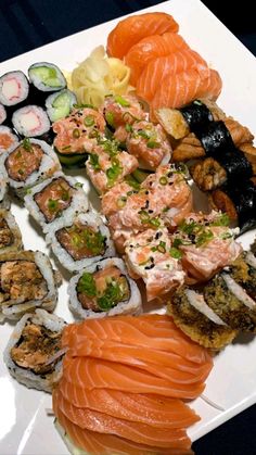 sushi platter with various types of salmons and other foods