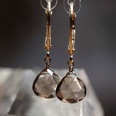 Beautiful natural smoky quartz earrings are handcrafted in 14k Gold and finished with leverback closure.  MATERIALS: * 14k Gold * natural Smoky Quartz * beautiful branded gift box + card about smoky quartz SIZE: stones: 8x8 mm; earrings: 2.5 cm or 1" MAKE A SET: Matching necklace: https://etsy.me/2DiWED2 SMOKY QUARTZ: * balances all Chakras In addition to the generic healing properties of Quartz, Smokey Quartz is an excellent grounding stone. It gently neutralizes negative vibrations and is deto Smokey Quartz Earrings, Smoky Quartz Earrings, Smokey Topaz, Smoky Topaz, All Chakras, Les Chakras, Quartz Jewelry, Leverback Earrings, Expensive Jewelry