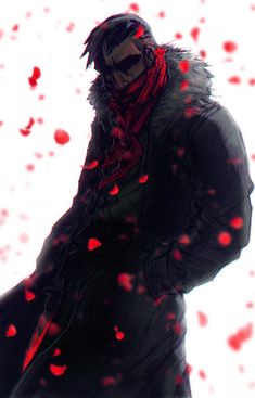 a man standing in the snow with his hands on his hips and wearing a red scarf