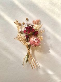 a bouquet of flowers sitting on top of a white surface