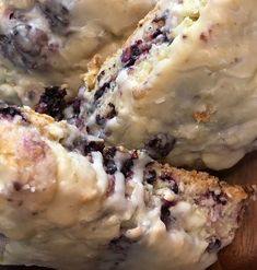 blueberry scones with icing on a wooden cutting board, ready to be eaten