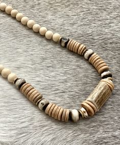 This unique necklace features a large antler bead in the middle surrounded by bone, brass and coconut wood beads. It measures approximately 27 inches long. Antler Beads, Deer Antler Necklace, Deer Antlers Necklace, Antler Jewelry, Coconut Wood, Antler Necklace, Deer Horn, Deer Antler, Unique Necklace