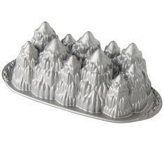 a cake pan filled with lots of frosting on top of a metal platter