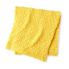 two yellow knitted napkins sitting on top of each other