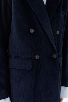 Our Navy double breasted tailored jacket is made of Organic Corduroy. The jacket features sustainable buttons and two front pockets with flaps. The lining is sustainable made from FSC & Eco Vera viscose. The jacket can be worn as a full suit with the matching corduroy wide leg trouser. Navy Tailored Outerwear With Double Button Closure, Tailored Double-breasted Blue Outerwear, Cotton Outerwear With Double-breasted Button And Notch Lapel, Luxury Navy Outerwear With Double-breasted Buttons, Tailored Navy Outerwear With Double-breasted Button Fastening, Double Breasted Jacket, Single Breasted Jacket, Tailored Jacket, Double Breasted Suit Jacket