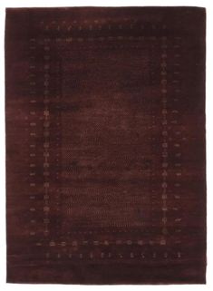 a brown area rug with squares and dots on the bottom, in front of a white background