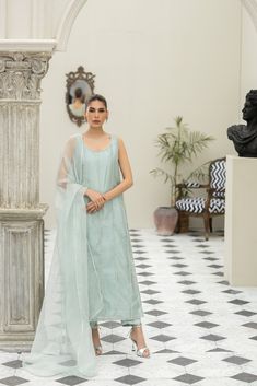 Meet our eye-catching Aqua-colored pure tissue long shirt hand worked in straight lines with pearls and zardozi and our signature big motif at the back of the shirt intricately handworked with resham, dabka, kora, sequins and beads. Paired with Rawsilk cigarette pants and a matching pure organza dupatta with a spray of handworked rosettes and pearls. Astoria Ny, Organza Dupatta, Straight Lines, Aqua Color, Raw Silk, Long Shirt, Aquamarine, Design Studio, Spray