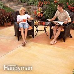 a man and woman sitting in chairs on a patio