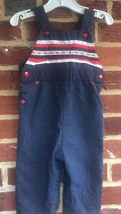 "Good vintage condition/being true vintage these runs very small/Waist 10 inches/inseam 7 inches/length 24 1/2 \"button can be moved up or down to make longer or shorter/Snap on each side/snap crotch for easy changing/Elastic on back is fully functional/smoke free environment(110)" Retro Cotton Shortalls With Bib Front, Retro Dark Wash Cotton Shortalls, Retro Cotton Dark Wash Shortalls, Retro Cotton Bib Front Shortalls, Vintage Bib Front Medium Wash Bottoms, Vintage Medium Wash Bib Front Bottoms, Vintage Cotton Overalls For Playtime, Vintage Blue Shortalls, Polly Flinders Dresses