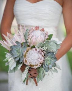 a bride holding a bouquet of flowers in her hands