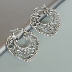 Indian style sterling silver filigree ear hoops. Dimensions: 31.5 x 33 mm weight: 5.8gm Price listed is for ONE PAIR These are made of 925 hypoallergenic sterling silver. Most of my pieces come with a 925 stamp. Can be packaged in a gift box. I can include a personal message from you if needed You are welcome to contact me at... bhavnakwintra1956@gmail.com For more beautiful pieces from my shop, please browse 👇 TOE RINGS: https://www.etsy.com/your/shops/TheSilverGame/tools/listings/section:2702 Ornate Silver Hoop Earrings With Intricate Design, Silver Filigree Small Hoop Jewelry, Bohemian Sterling Silver Heart Earrings, Silver Sterling Silver Hoop Earrings With Filigree, Silver Hoop Earrings With Intricate Design As Gift, Nickel Free Small Hoop Silver Heart Earrings, Nickel Free Silver Hoop Heart Earrings, Silver Metal Hoop Earrings For Wedding, Nickel-free Small Hoop Heart Earrings In Silver