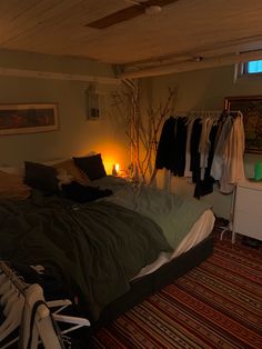 a bedroom with clothes hanging on the wall