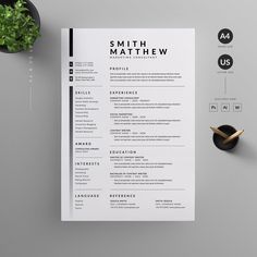 a clean and modern resume template on a desk with a plant next to it,