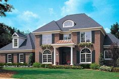 a large brick house with lots of windows