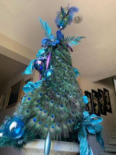 a peacock is standing on top of a fireplace mantel with ornaments around its neck