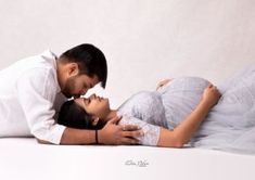 a man and woman are laying on the floor with their heads close to each other