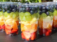 several cups filled with fruit sitting on top of a table