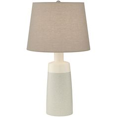 a white table lamp with a beige shade