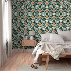 a bedroom with green and orange wallpaper