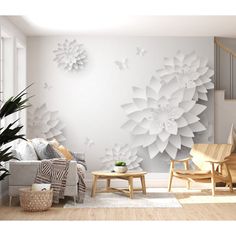 a living room filled with furniture and a large white flower wall mural on the wall