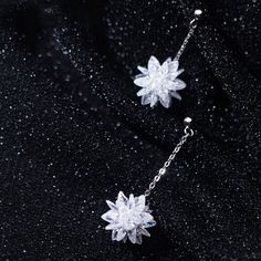 This pair of snow flower dangle drop earrings features a beautiful snowflake / lotus flower in white crystal with dangle chain made of solid 925 sterling silver with platinum platting. Add this pair of white flower dangle drop earrings to your everyday fine jewelry collection or as gift for your love one this Christmas holiday season. Jewelry Care: See more information about how to care for your jewelry here. Shipping Policy: Orders will be shipped within 1-3 business days. Economy shipping will Winter Inspired Jewelry, White Sterling Silver Flower Earrings For Party, Silver Crystal Flower Earrings For Gift, Silver Crystal Flower-shaped Earrings, Snow Jewelry, Snow Earrings, Christmas Gift Earrings, Snowflake Jewelry, Snow Flower