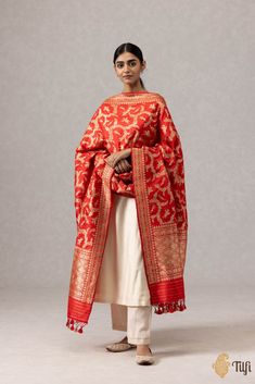 "A stunning red\u00a0handloom\u00a0masterpiece\u00a0in an exquisite Shikaargah design, featuring a\u00a0beautiful\u00a0web of zari, figures and animal motifs crafted in zari.\u00a0\n\u00a0\n\n\n\nColor\u00a0-\u00a0A ravishing\u00a0shade of\u00a0Red\n\n\n Technique\u00a0-\u00a0Classic handwoven Banarasi art passed down through generations of weaving traditions and an enduring Kadwa weave. The elaborate and laborious Kadwa (Kadhua) technique involves hand-weaving each motif separately. It takes longer on the handloom, but makes a more robust pattern which stands out on the fabric.\u00a0\n\n\n Fabric\u00a0- Soft as butter, pure Katan silk\n\n Speciality\u00a0- A luxurious drape, an opulent zari jaal, and incredibly detailed animal motifs in the finest Kadhua weave.\u00a0\n\n Tilfi Promise\u00 Jungle Scene, Animal Motifs, Katan Silk, Hand Weaving, Take That, Silk, Pure Products, Red, Pattern