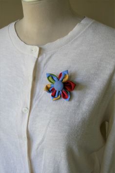 a close up of a person wearing a white shirt with a colorful flower on it