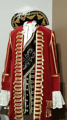 a red and black jacket with white ruffles on it