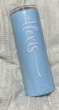 a blue and white tumbler with the words goodbye on it sitting on a blanket