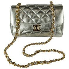 Unusual Chanel Metallic Silver Lambskin Shoulder Mini with black lining with original 24K gold plated hardware and original strap. Adorable mini size but a practical mini that can actually hold quite a lot (phones, wallets, etc.) 1990's France w. card. 7.5" x 5" x 2" deep. Strap 17" drop. 24k gold plated hardware. Bag Silver, Mini Shoulder Bag, Fashion Handbags, Chanel Bag, Metallic Silver, Wallets, Gold Plate, Chanel, Wallet