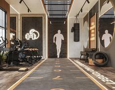 a man is walking down the hall in front of mirrors and exercise equipment on display