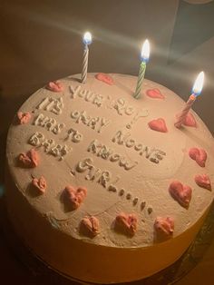 a birthday cake with hearts and candles on it