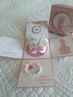 there are cards and brochures on the bed with pink ribbon around them,