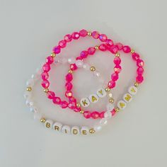 Welcome to CraftylilStudio!  This listing is for ONE personalized  bracelet. 🌸These sparkly bracelets are a Perfect gift for a bridesmaid, friend or just for yourself. Bracelets come in organza string bags, perfect for gifting. 😊 DETAILS: -Each bracelet is handmade just for you!  -Made with Iridescent Acrylic beads and 18k gold plated accents.  -Made with High quality clear jewelry elastic cord. -Leave Name or word and Letter bead style  number in personalization box at checkout. Pleaso also use personalization box to leave  custom size  if chosen from drop down menu.  -All orders are FINAL as each bracelet is custom made. Please measure your wrist and spelling  before purchasing.  -Measure wrist were you want the bracelet then add 1/2 an inch to that measurement. This will account for b Personalized Bracelets For Bridesmaid Gift On Valentine's Day, Customizable Elegant Beaded Bracelets For Personalized Gifts, Customizable Pink Bracelet Jewelry, Elegant Customizable Beaded Bracelets For Personalized Gifts, Handmade Pink Crystal Bracelet For Wedding, Customizable Pink Jewelry For Personalized Gift, Handmade Bracelets For Bridesmaid Gift, Adjustable Pink Crystal Bracelet For Wedding, Customizable Pink Bracelets For Gifts