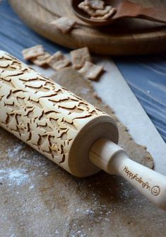 a wooden rolling pin sitting on top of a table