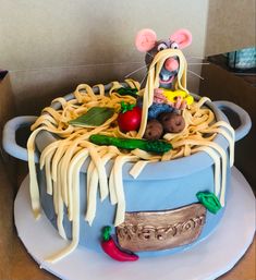 a cake that looks like spaghetti with mouse on top