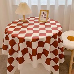 a red and white table with a lamp on it