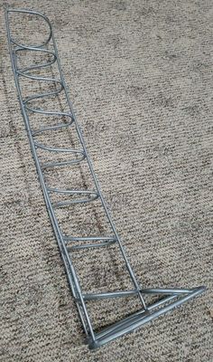 a metal ladder laying on top of a carpet