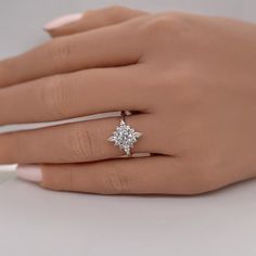 a woman's hand with a diamond ring on it