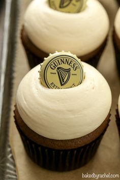 cupcakes with white frosting and a guinness bottle cap