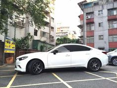 a white car parked in the middle of a parking lot